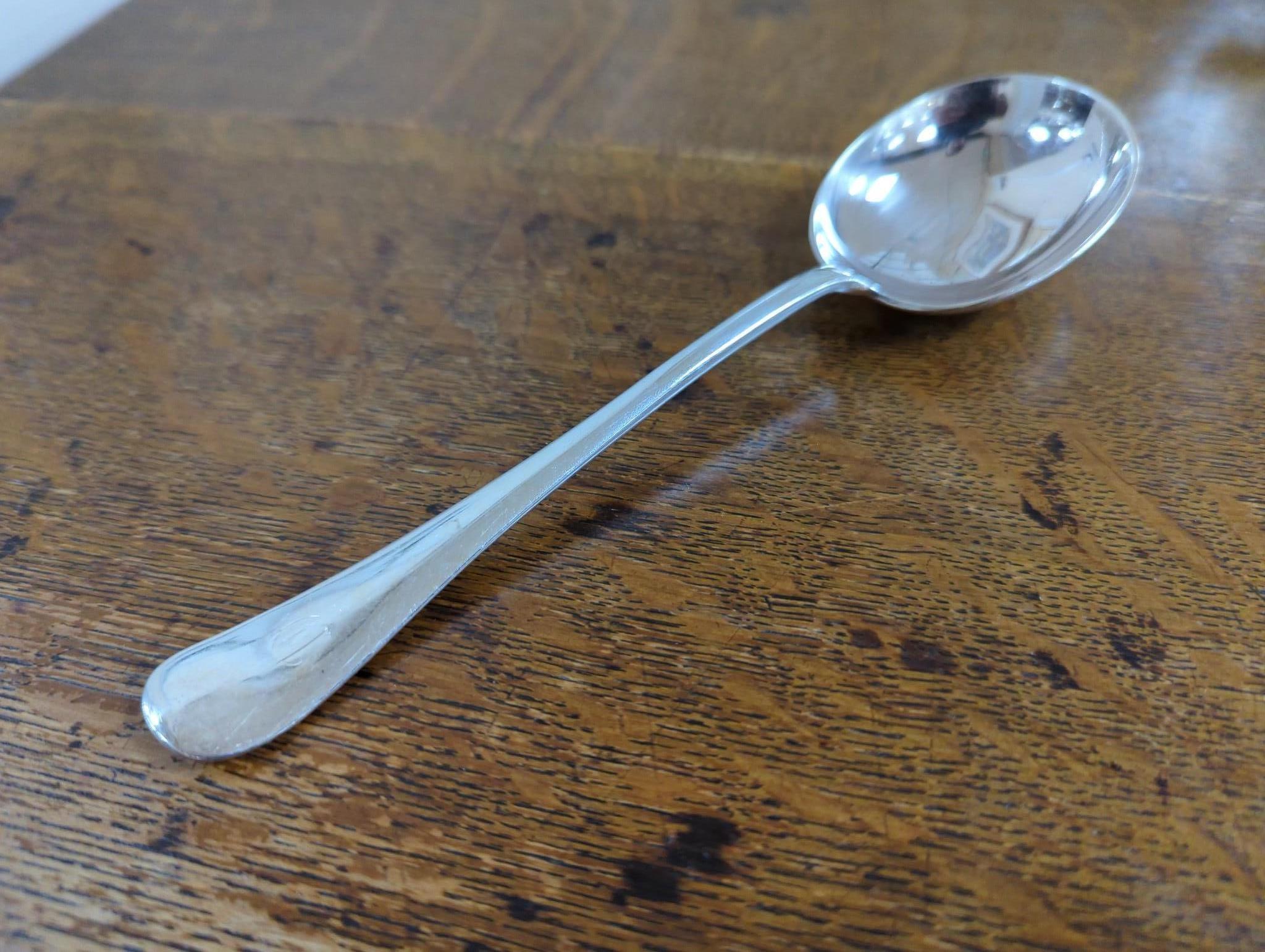 An Edwardian oak cased silver plated table canteen, settings for twelve and a set of silver plated fish knives and forks for twelve